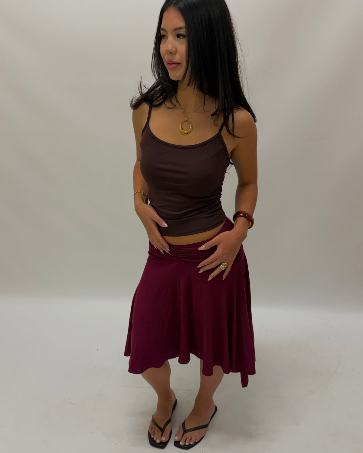 a woman wearing a large gold pendant on a necklace and waterproof jewellery