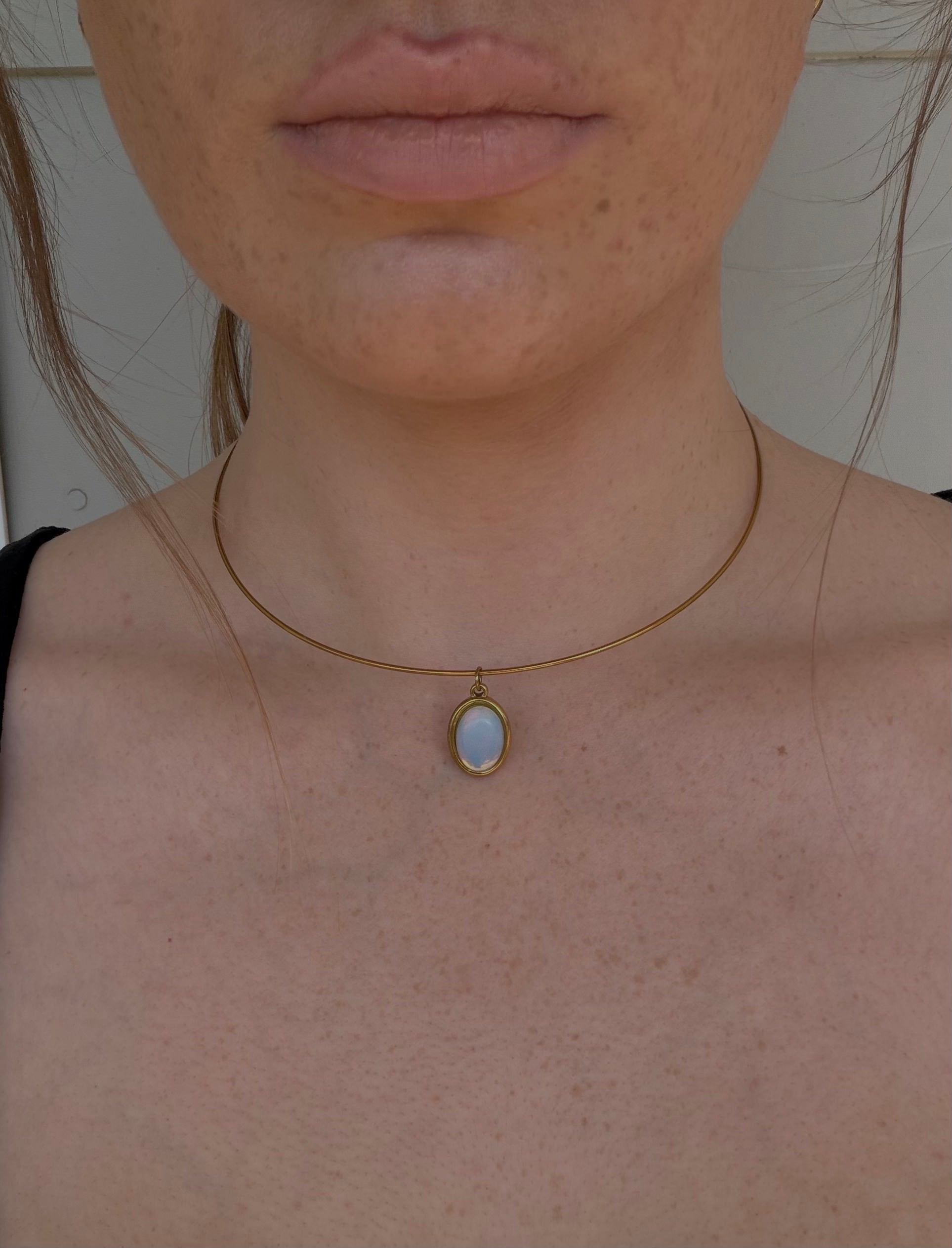 wire choker necklace with a blue stone pendant