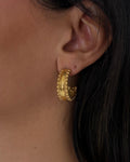 textured gold hoop earrings with beading details. waterproof and tarnish resisant stainless steel.