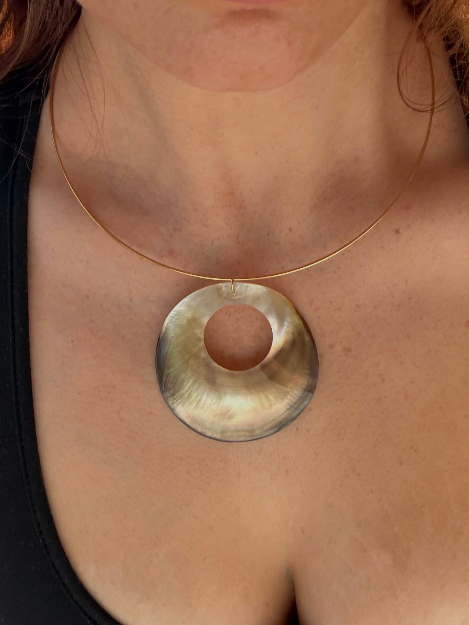 Large mother of pearl pendant on a waterproof stainless steel wire necklace.